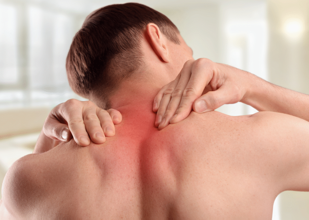 Man holding his neck and upper back in pain, possibly due to a cervical disc problem.