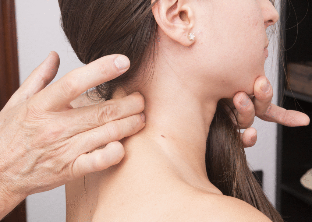 Physiotherapist examining a woman's neck for cervical disc issues or misalignment.