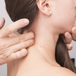 Physiotherapist examining a woman's neck for cervical disc issues or misalignment.